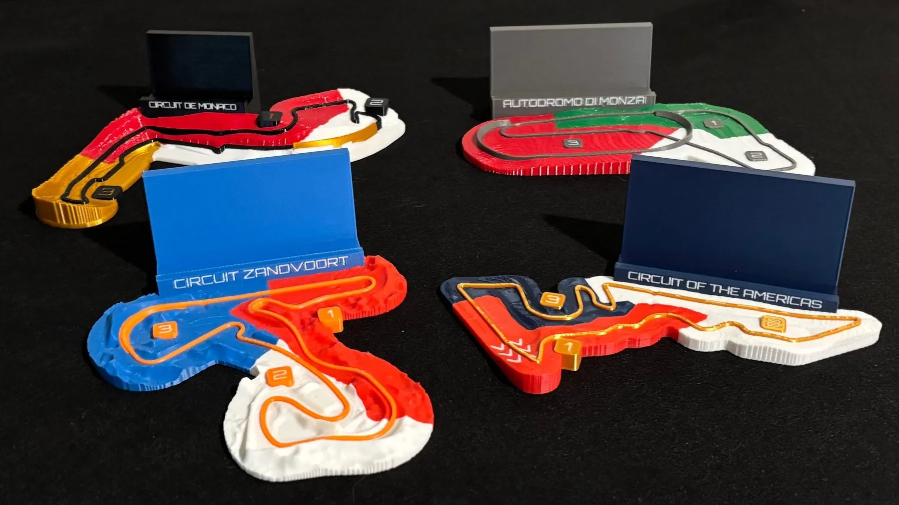 Four Racing Lines circuit plates printed in four filament colours each
